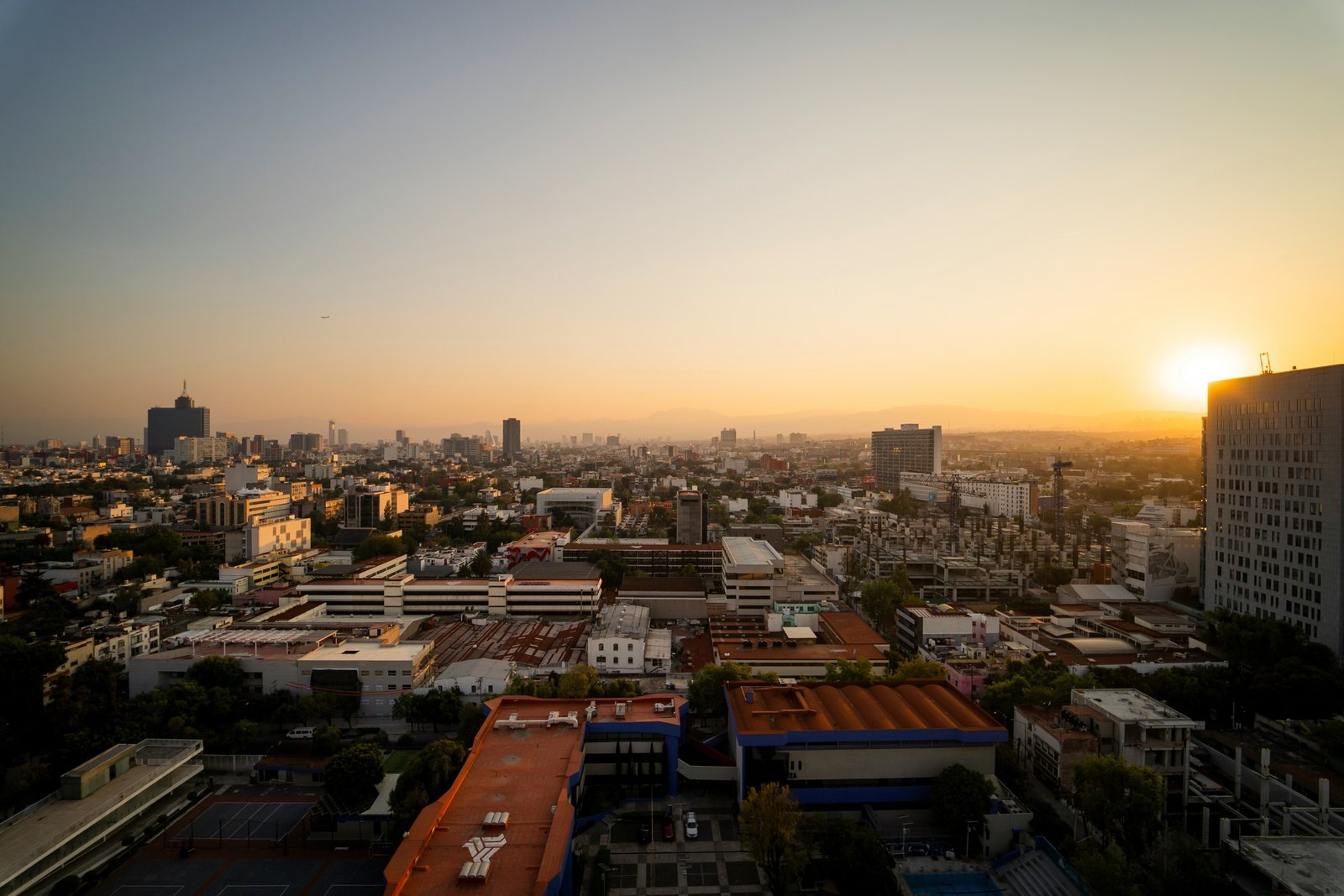 A wide city and industrial landscape at sunrise